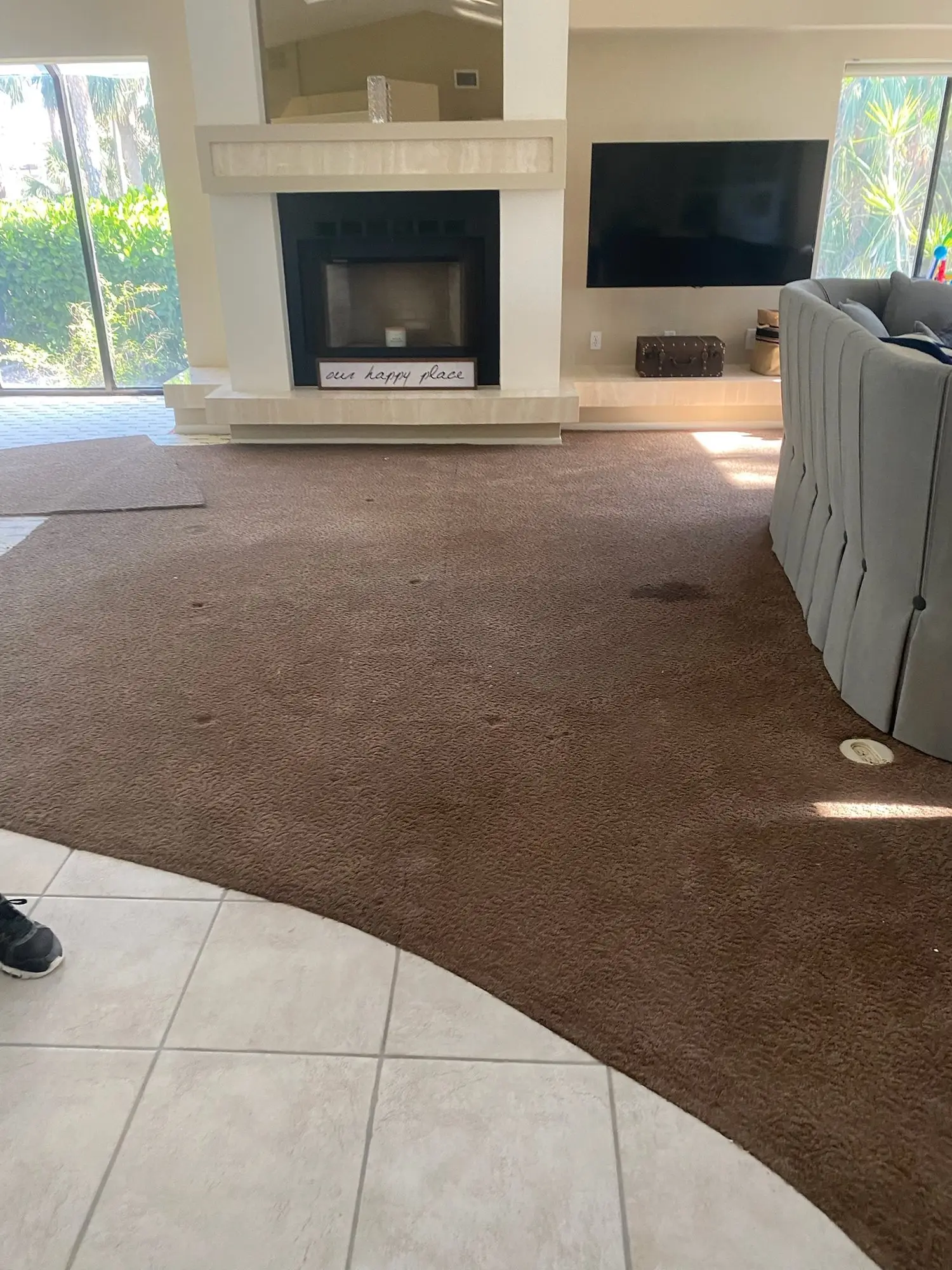 Before: Carpet and tile removed, slab leveled, plank installed