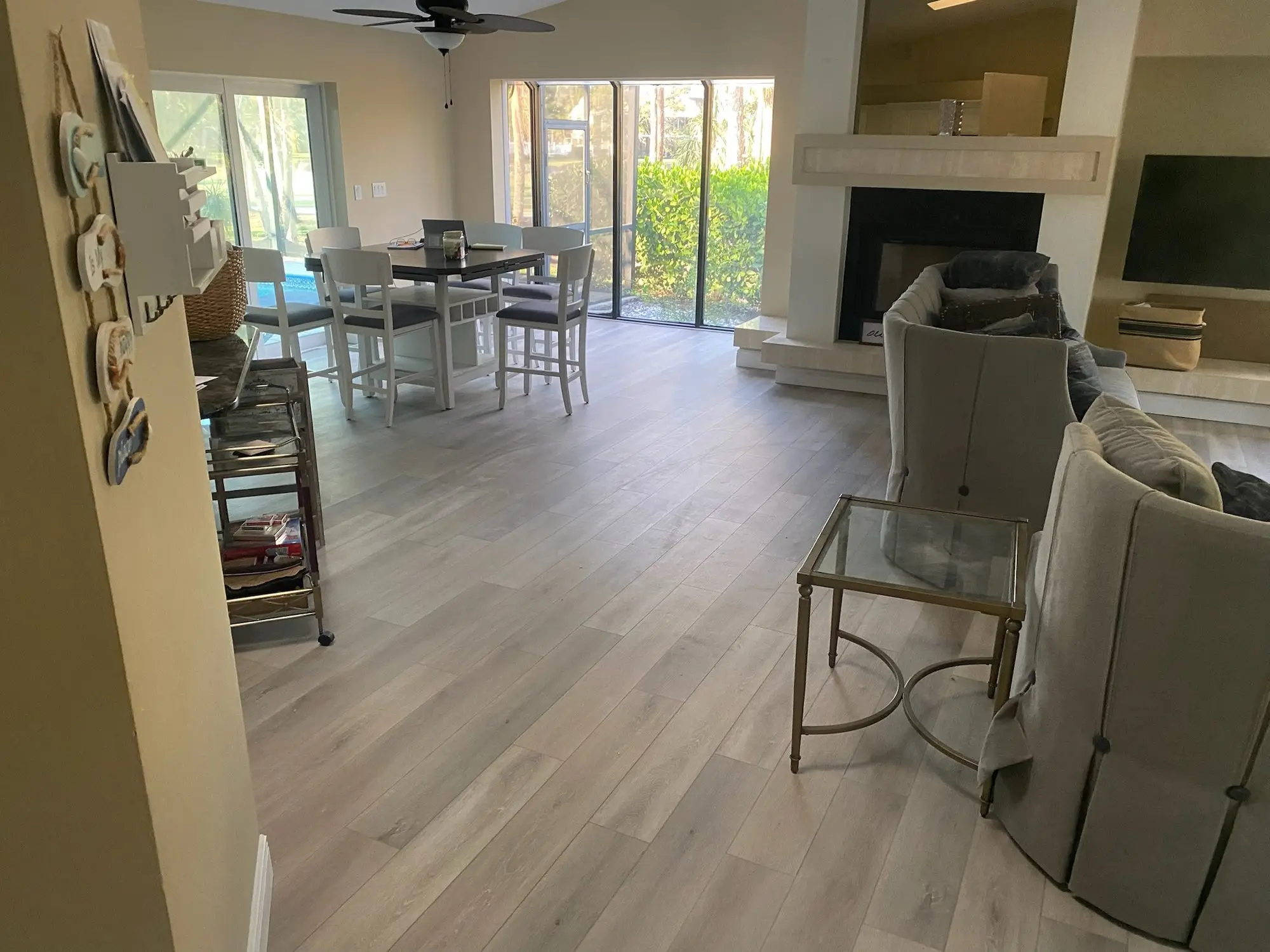After: Carpet and tile removed, slab leveled, plank installed